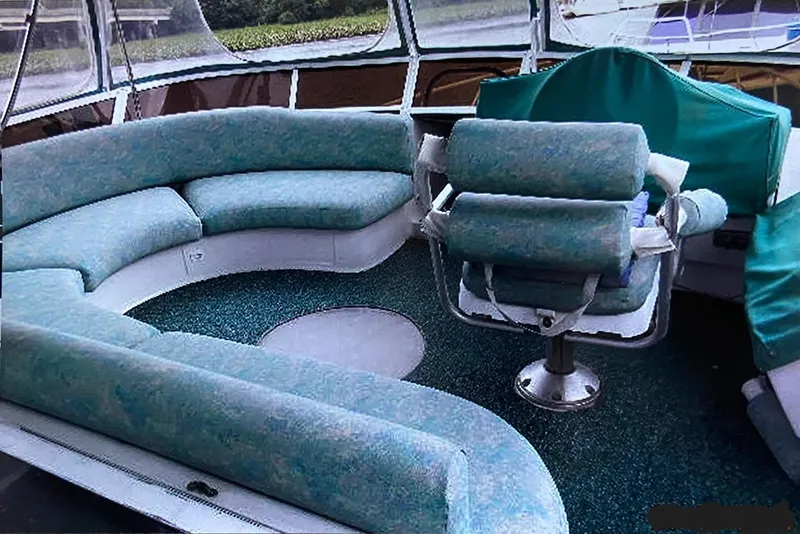 Slide: The Image of 1993 Mainship 36 Express boat interior with curved seating and captain's chair. - 15