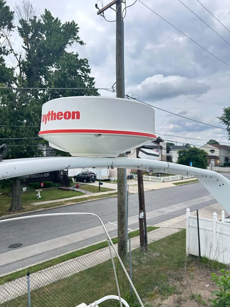 Slide: The Image of Radar equipment on a 1993 Mainship 36 Express boat, near a residential street. - 17