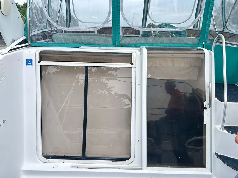 Slide: The Image of 1993 Mainship 36 Express boat with sliding door and clear canopy. - 18