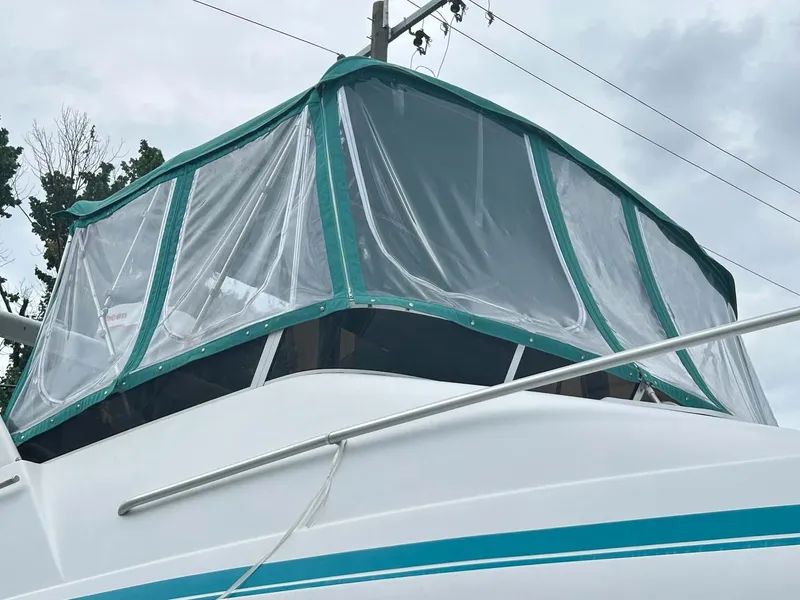 Slide: The Image of 1993 Mainship 36 Express boat with green canopy and clear panels. - 19