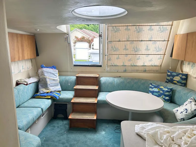 Slide: The Image of Interior of 1993 Mainship 36 Express with cozy seating and round table. - 3