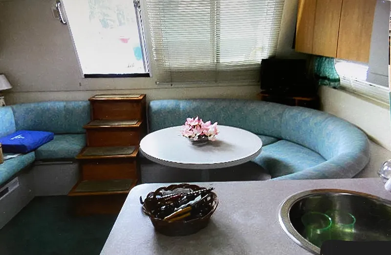 Slide: The Image of Interior of 1993 Mainship 36 Express with cozy seating and dining area. - 4