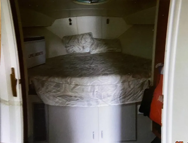 Slide: The Image of 1993 Mainship 36 Express cabin interior with bed and storage cabinets. - 8