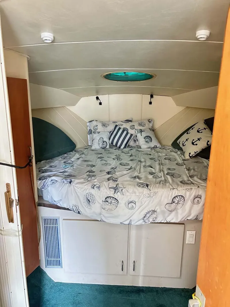 Slide: The Image of 1993 Mainship 36 Express cabin with cozy bed and nautical-themed decor. - 9