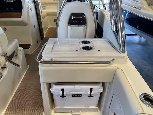 Slide: The Image of 2022 Chris-Craft Calypso 24 interior with Yeti cooler and cup holders. - 12
