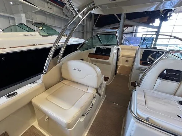 Slide: The Image of 2022 Chris-Craft Calypso 24 boat interior with beige seating and modern dashboard. - 14