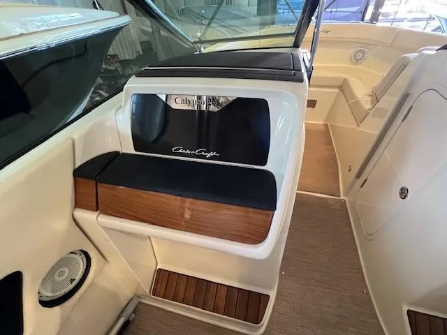 Slide: The Image of 2022 Chris-Craft Calypso 24 interior with seating and storage compartments. - 15