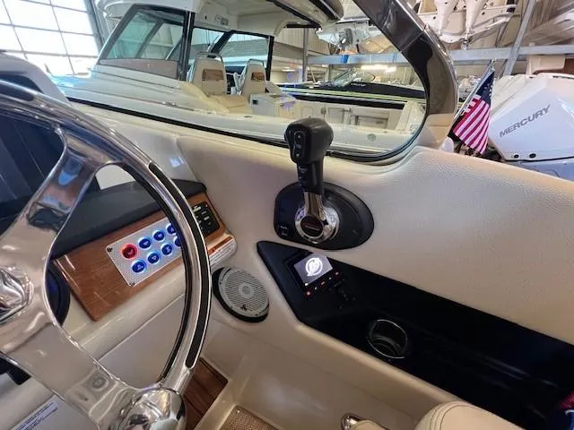 Slide: The Image of 2022 Chris-Craft Calypso 24 boat interior, steering wheel, control panel, and throttle. - 16