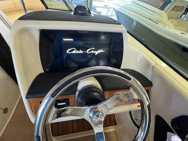 Slide: The Image of 2022 Chris-Craft Calypso 24 helm with Garmin display and Fusion stereo. - 17