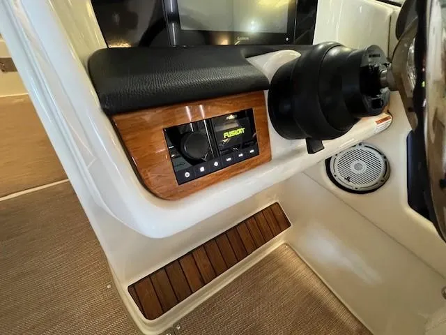 Slide: The Image of 2022 Chris-Craft Calypso 24 dashboard with Fusion audio system and steering wheel. - 19