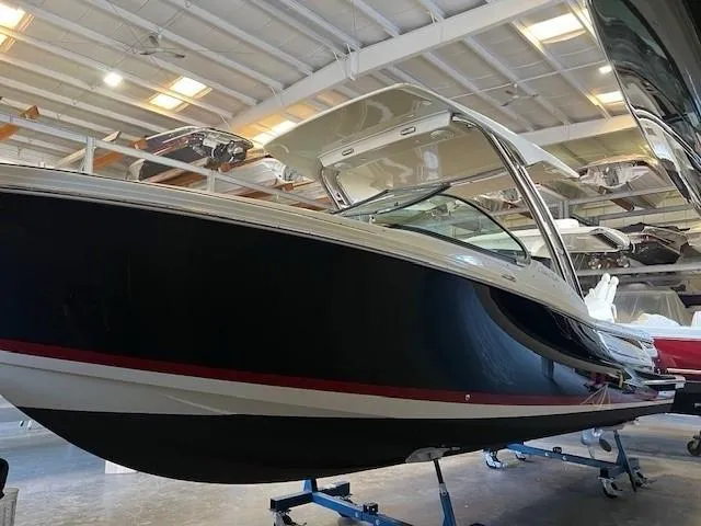 Slide: The Image of 2022 Chris-Craft Calypso 24 boat in indoor storage facility. - 2