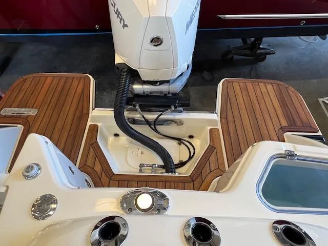 Slide: The Image of 2022 Chris-Craft Calypso 24 boat stern with Mercury outboard motor and teak decking. - 23