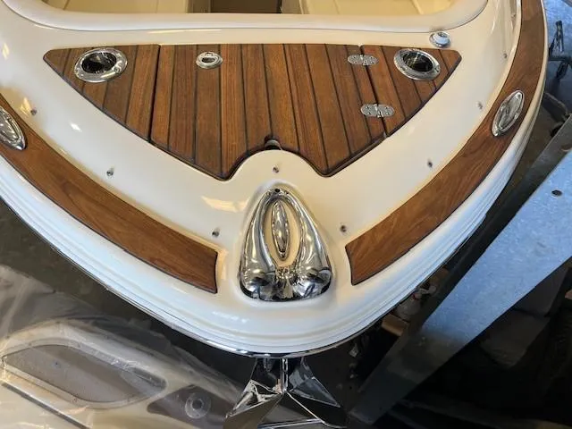 Slide: The Image of 2022 Chris-Craft Calypso 24 boat bow with teak decking and chrome fixtures. - 4