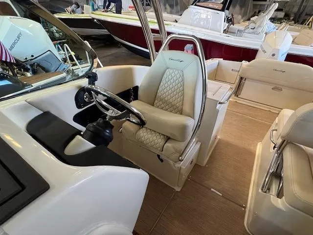 Slide: The Image of 2022 Chris-Craft Calypso 24 boat interior with captain's chair and steering wheel. - 9