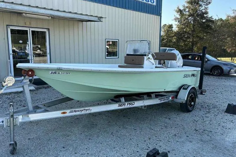 Slide: The Image of 2024 Sea Pro 172 Bay boat on trailer, parked outside a building. - 10