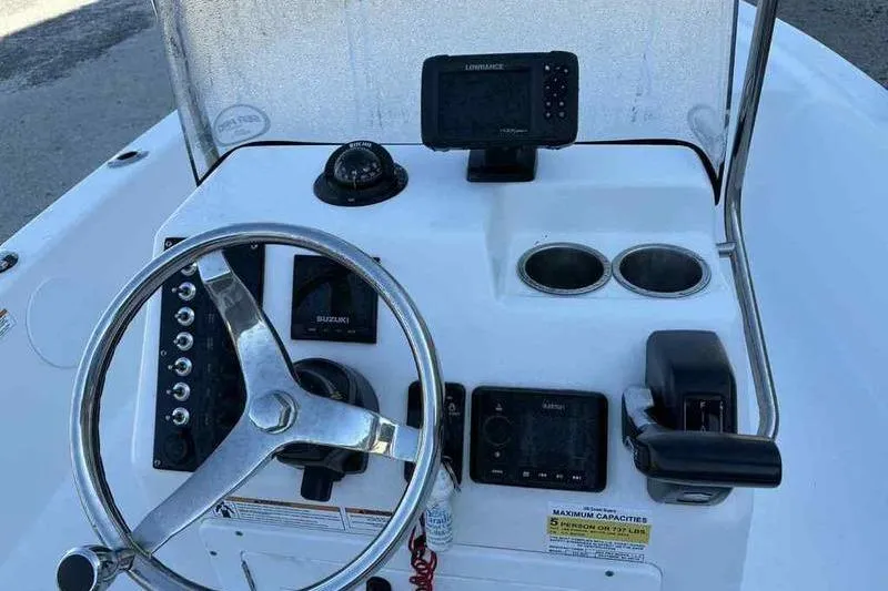 Slide: The Image of 2024 Sea Pro 172 Bay boat dashboard with steering wheel and navigation equipment. - 12
