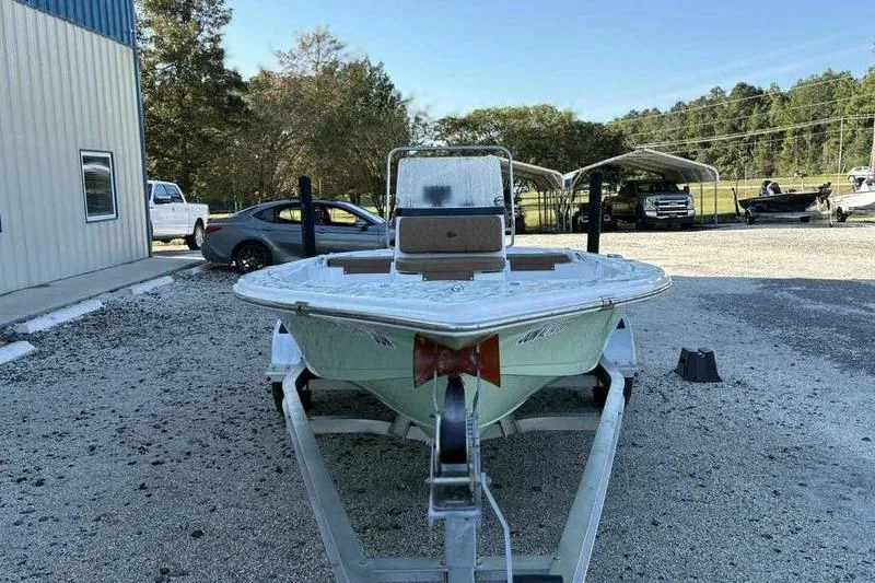 Slide: The Image of 2024 Sea Pro 172 Bay boat on trailer, parked outdoors near a building. - 13