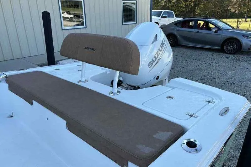 Slide: The Image of 2024 Sea Pro 172 Bay boat with Suzuki outboard motor, parked near a building. - 6