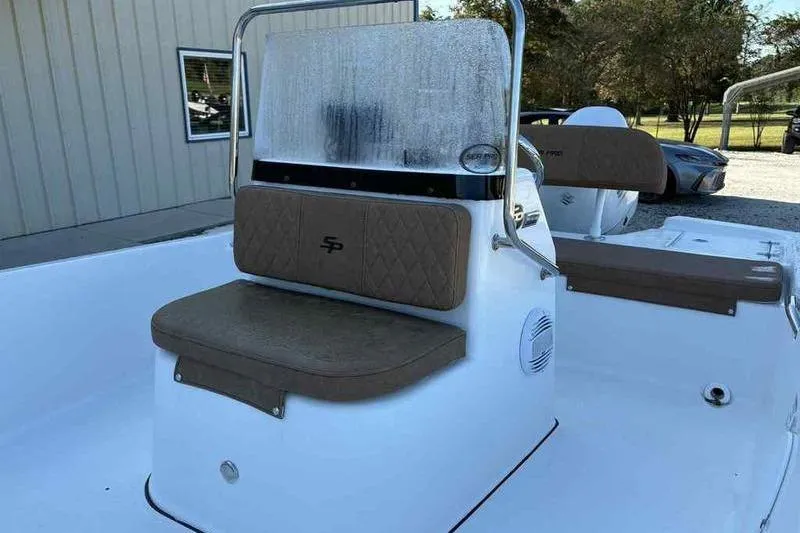 Slide: The Image of 2024 Sea Pro 172 Bay boat interior with brown cushioned seating and windshield. - 7