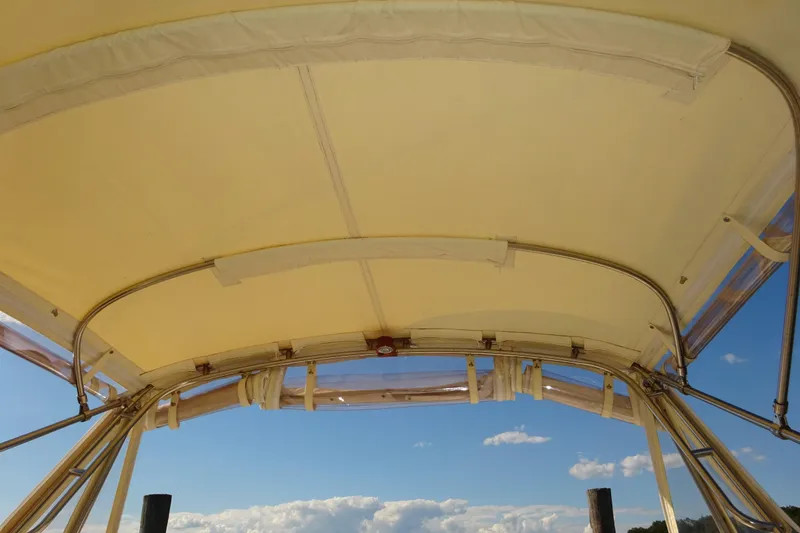 Slide: The Image of 2007 Hunt Yachts Surfhunter 29 canopy with clear sky background. - 28