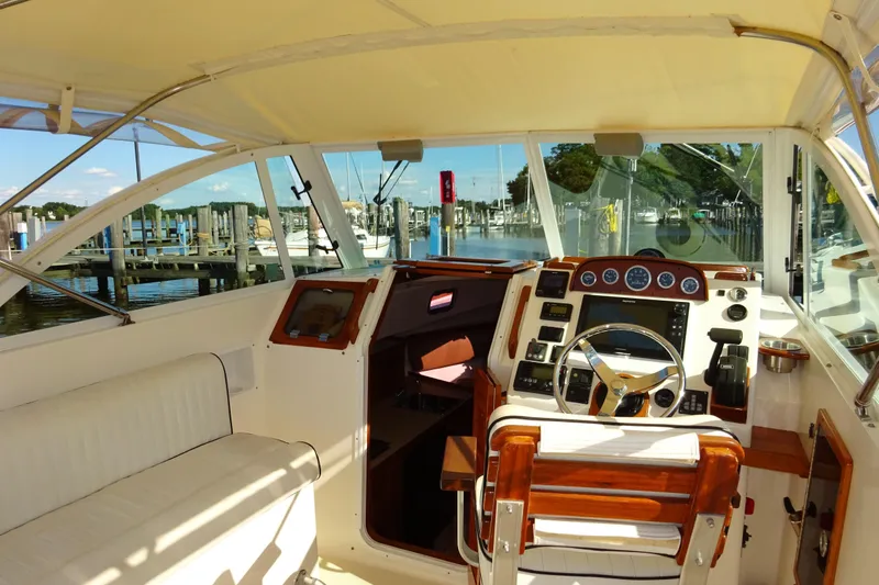 Slide: The Image of 2007 Hunt Yachts Surfhunter 29 cockpit with steering wheel and marina view. - 30
