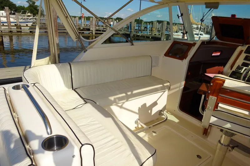 Slide: The Image of 2007 Hunt Yachts Surfhunter 29 interior with white seating and helm, docked at marina. - 33