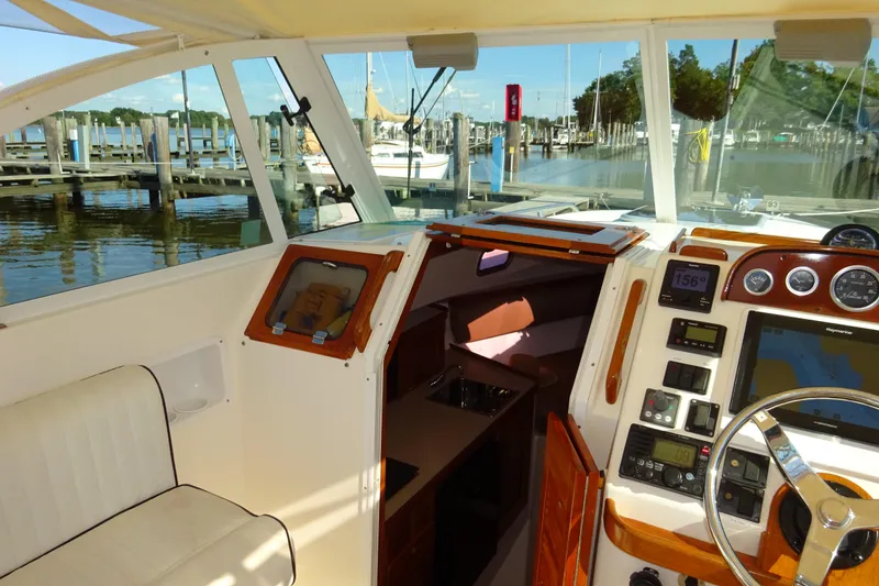 Slide: The Image of 2007 Hunt Yachts Surfhunter 29 cockpit with navigation instruments, docked at marina. - 37