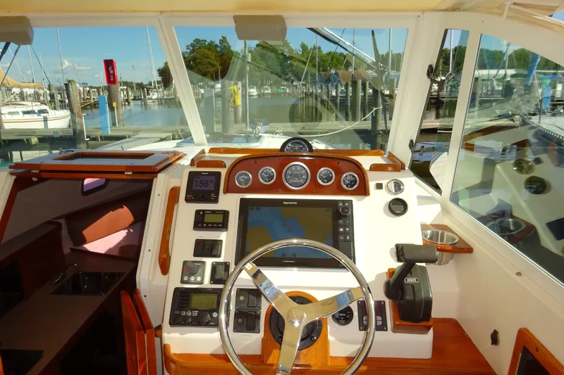 Slide: The Image of 2007 Hunt Yachts Surfhunter 29 helm with navigation instruments and marina view. - 41