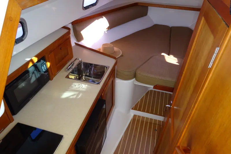 Slide: The Image of 2007 Hunt Yachts Surfhunter 29 cabin interior with kitchenette and cozy sleeping area. - 43