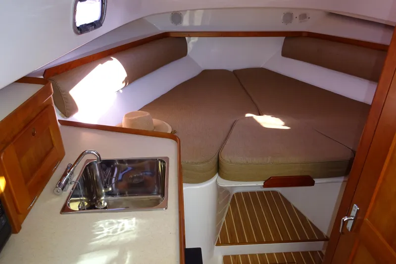 Slide: The Image of 2007 Hunt Yachts Surfhunter 29 cabin interior with sink and cozy sleeping area. - 45