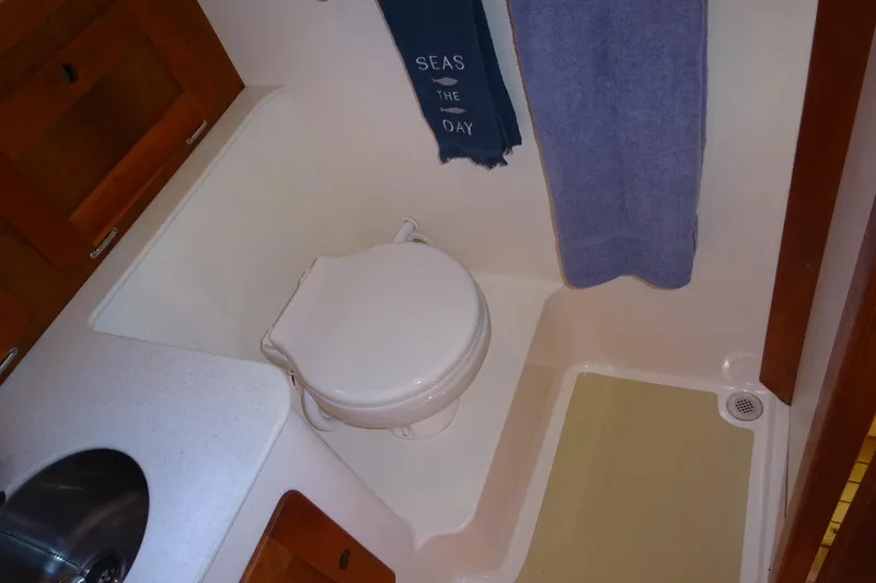 Slide: The Image of 2007 Hunt Yachts Surfhunter 29 bathroom with toilet, sink, and towel. - 52