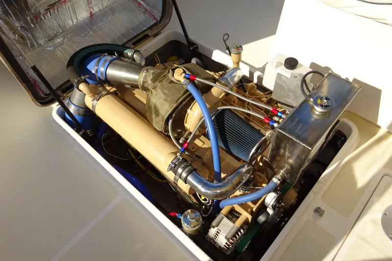 Slide: The Image of Engine compartment of 2007 Hunt Yachts Surfhunter 29, showcasing detailed mechanical components. - 54