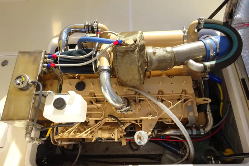 Slide: The Image of Engine compartment of a 2007 Hunt Yachts Surfhunter 29, showcasing detailed mechanical components. - 58