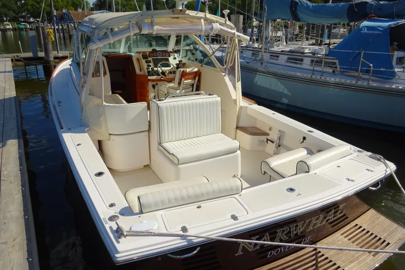 Slide: The Image of 2007 Hunt Yachts Surfhunter 29 docked, featuring spacious seating and elegant design. - 9