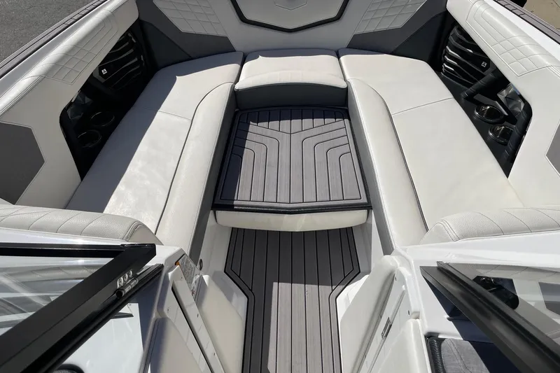 Slide: The Image of 2023 Nautique Super Air Nautique G25 interior with luxurious seating and sleek design. - 11