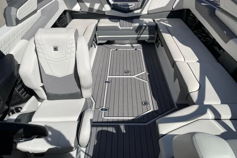 Slide: The Image of 2023 Nautique Super Air Nautique G25 interior with luxurious seating and modern design. - 12