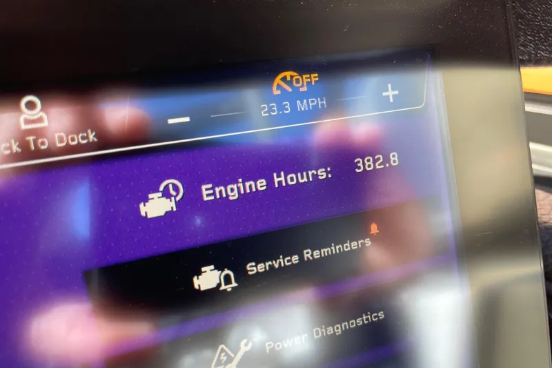 Slide: The Image of Display screen of 2023 Nautique Super Air Nautique G25 showing engine hours and speed. - 13