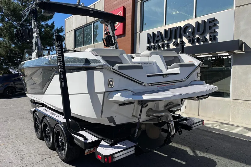 Slide: The Image of 2023 Nautique Super Air Nautique G25 boat on trailer at dealership. - 3