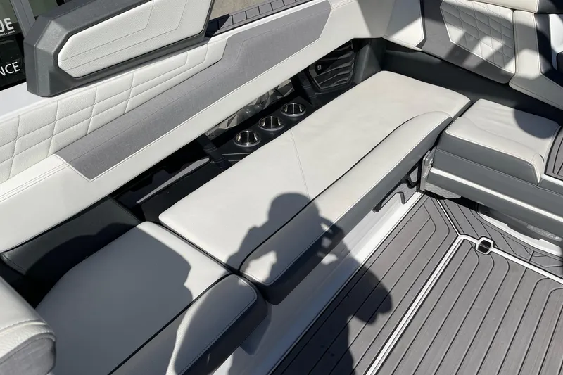 Slide: The Image of 2023 Nautique Super Air Nautique G25 interior seating with cup holders and modern design. - 7