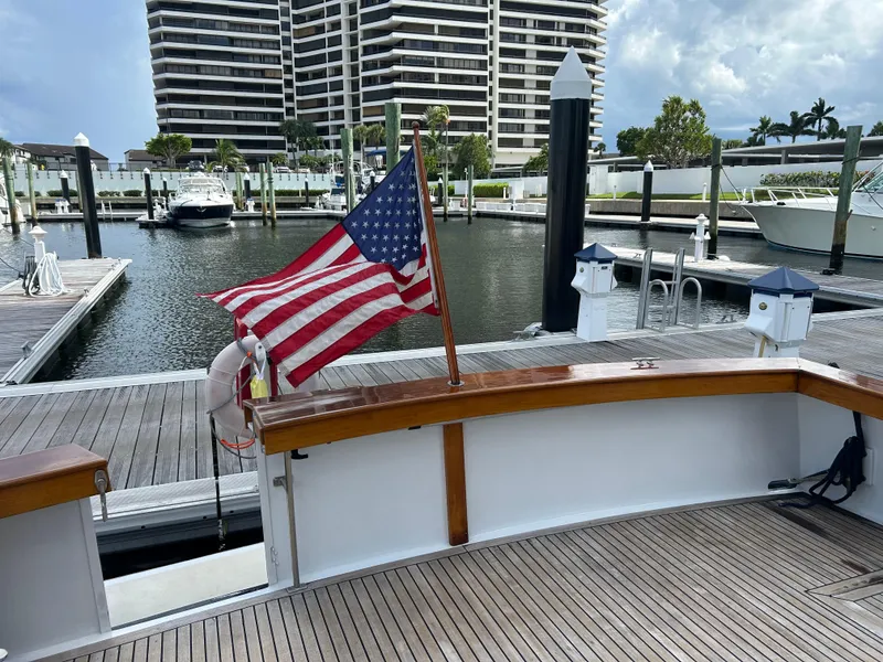 Slide: The Image of 1987 Lyman-Morse Downeast Flybridge at marina, American flag, waterfront view. - 26