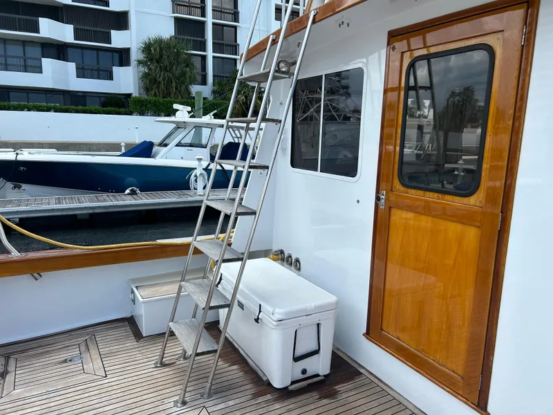 Slide: The Image of 1987 Lyman-Morse Downeast Flybridge boat with wooden door and ladder on deck. - 27