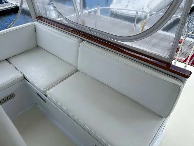 Slide: The Image of 1987 Lyman-Morse Downeast Flybridge interior with white cushioned seating. - 31