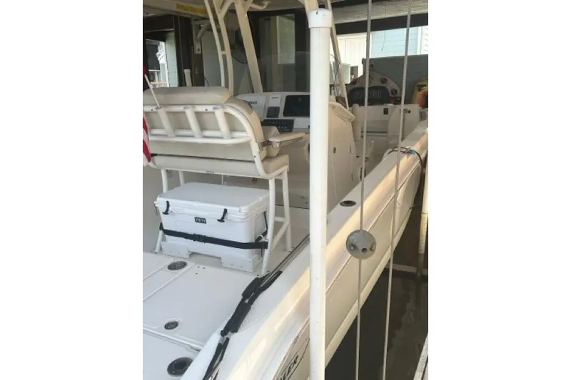 Slide: The Image of 2024 Boston Whaler 250 Dauntless boat interior with seating and cooler. - 11