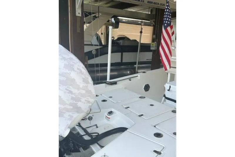 Slide: The Image of 2024 Boston Whaler 250 Dauntless boat interior with American flag and storage compartments. - 12