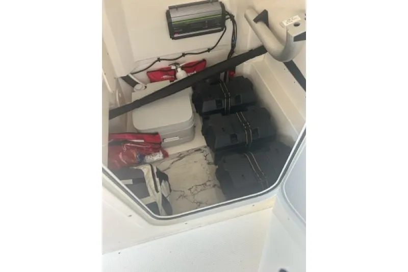 Slide: The Image of 2024 Boston Whaler 250 Dauntless interior storage with equipment and supplies. - 3
