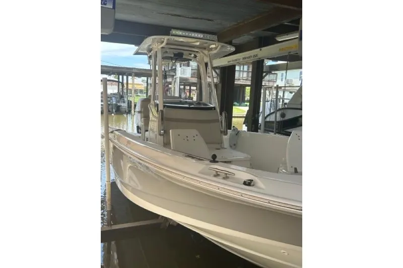 Slide: The Image of 2024 Boston Whaler 250 Dauntless boat docked in a marina. - 5