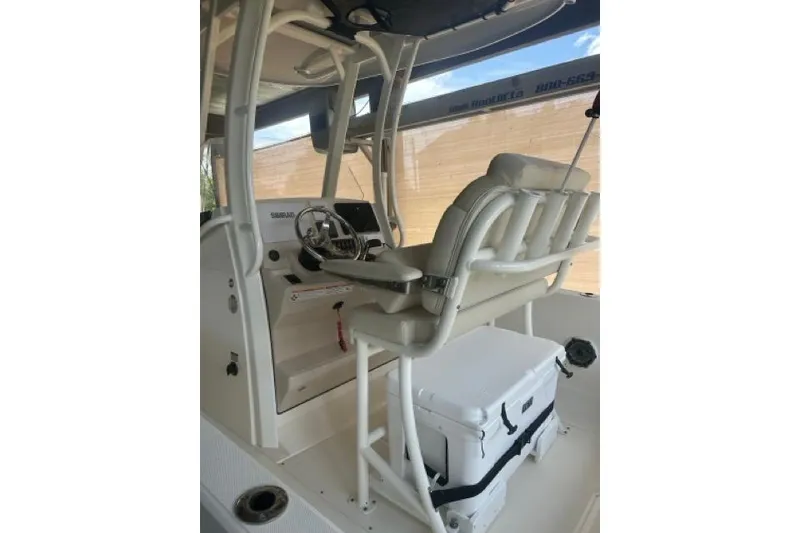 Slide: The Image of 2024 Boston Whaler 250 Dauntless boat interior with helm and seating area. - 8