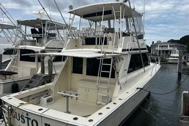 The Image of 1988 Viking 45 Convertible boat docked, featuring spacious deck and flybridge. - 0