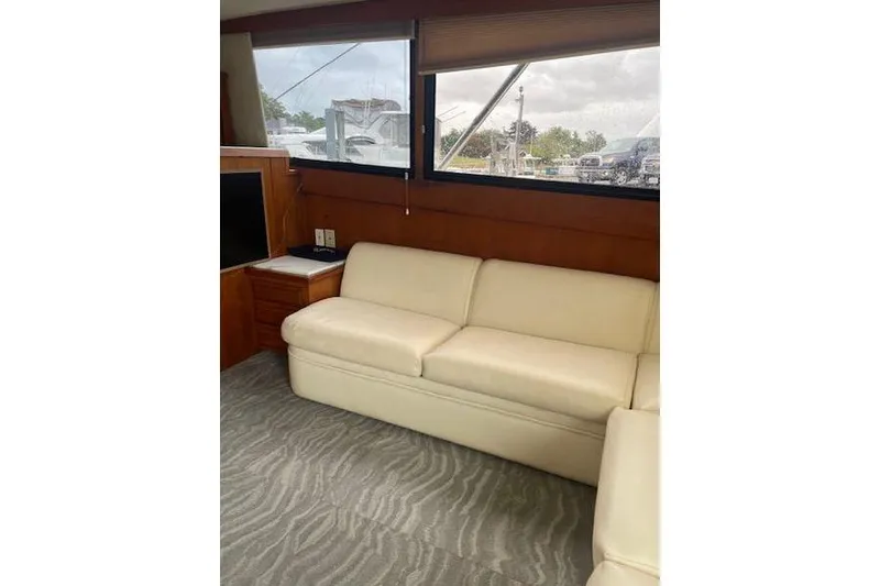 Slide: The Image of Interior of 1988 Viking 45 Convertible yacht with cream sofa and large windows. - 10