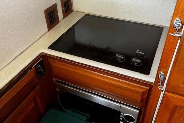 Slide: The Image of 1988 Viking 45 Convertible yacht kitchen with stovetop and microwave. - 13